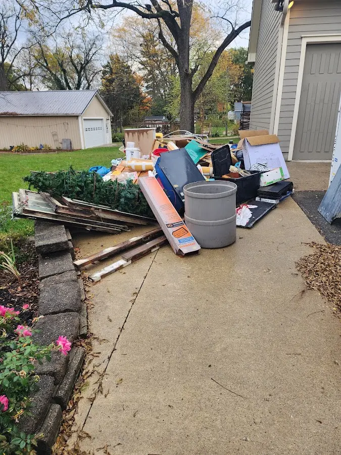 Dumpster being loaded with debris for 30 Yard Dumpster Rental in Zumbrota